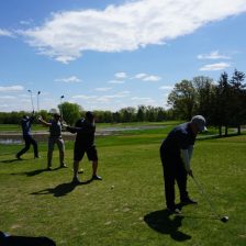Four golfers tee off