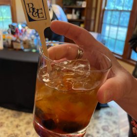 drink in hand with B&E stir stick
